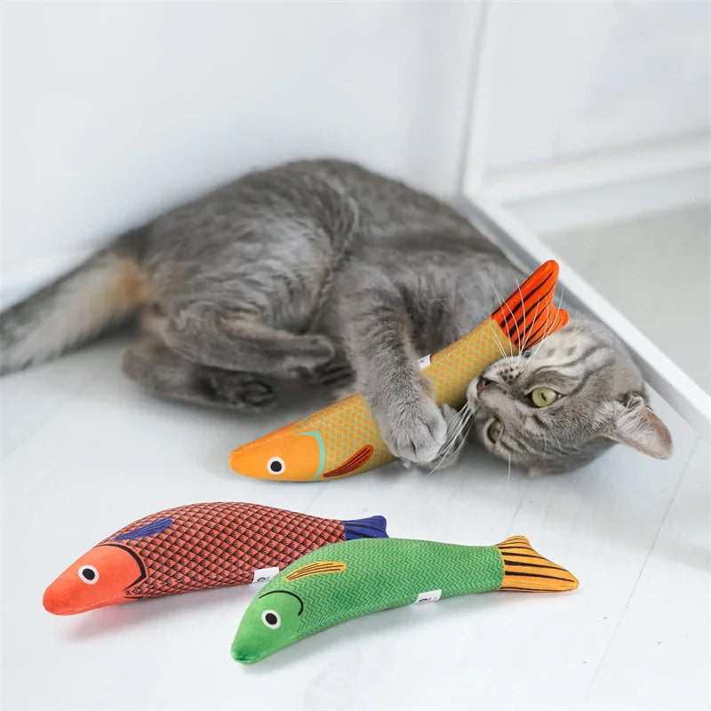 “orange kitten playing with 3D catnip fish plush interactive toy”